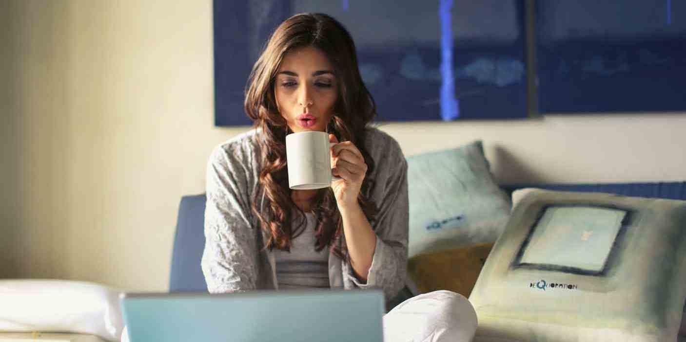 Woman on bed with coffee